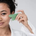 Grön ansikts Gua Sha